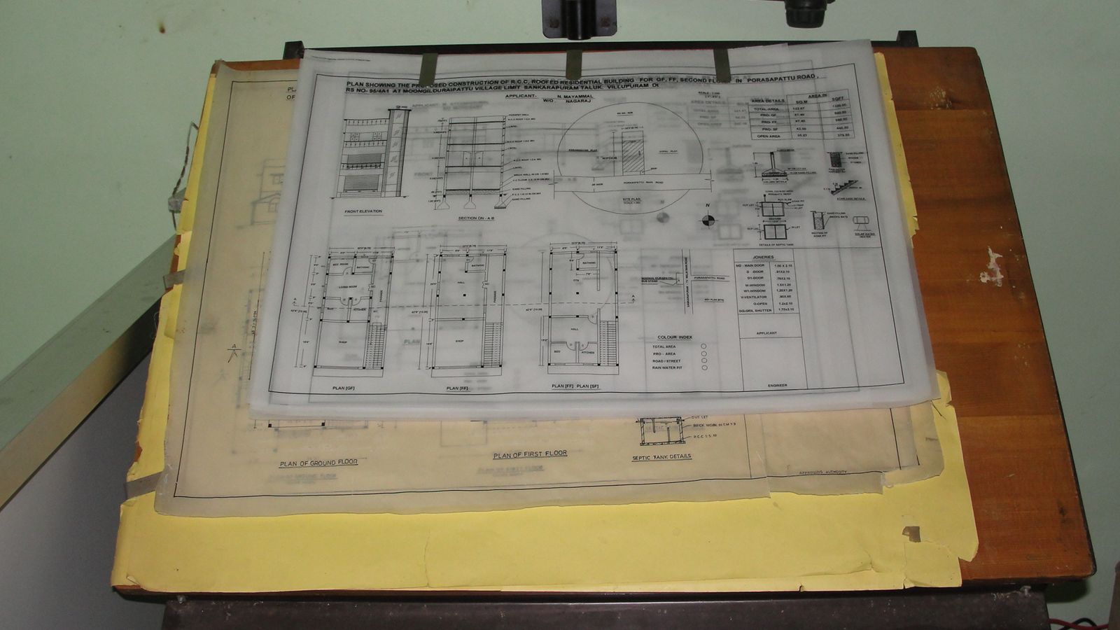 House plans and drawings spread out on a drafting table