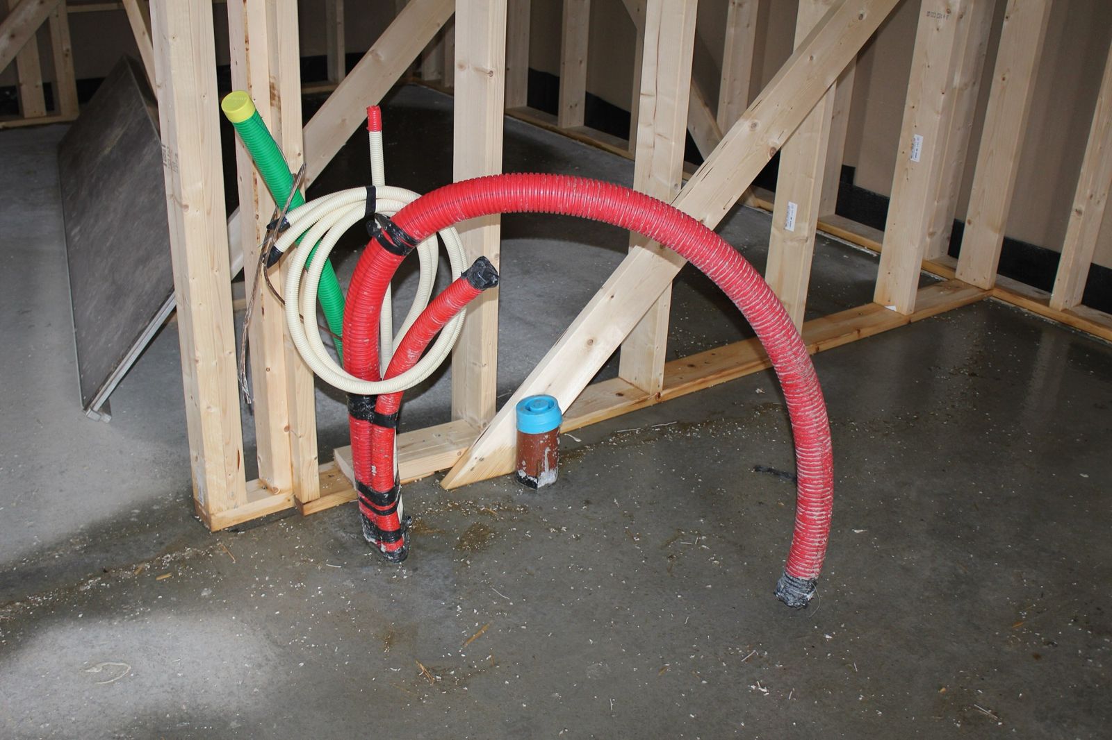 Concrete floor with pipe openings prepared for new plumbing connections