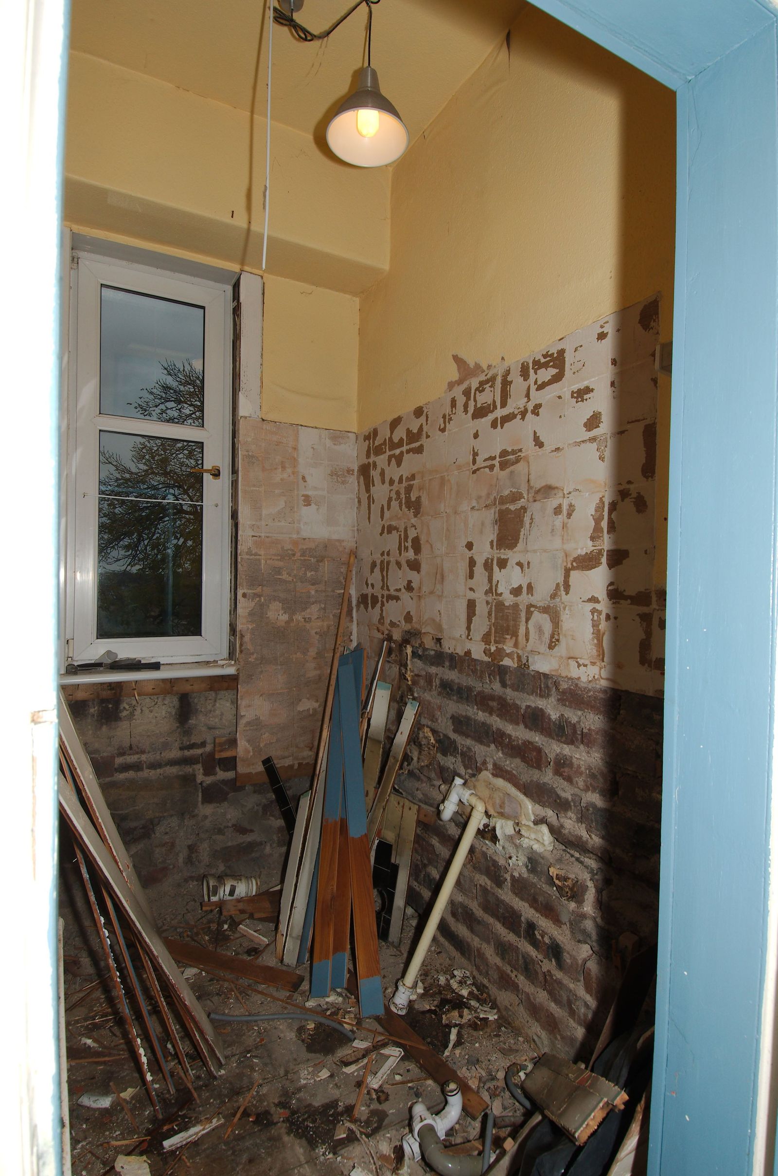 Bathroom stripped back to bare brick walls before renovation