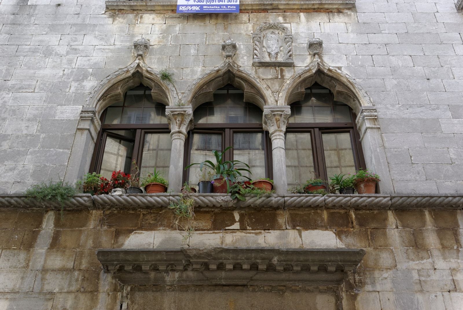 Gothic stone house with arched windows in the old town of Poreč