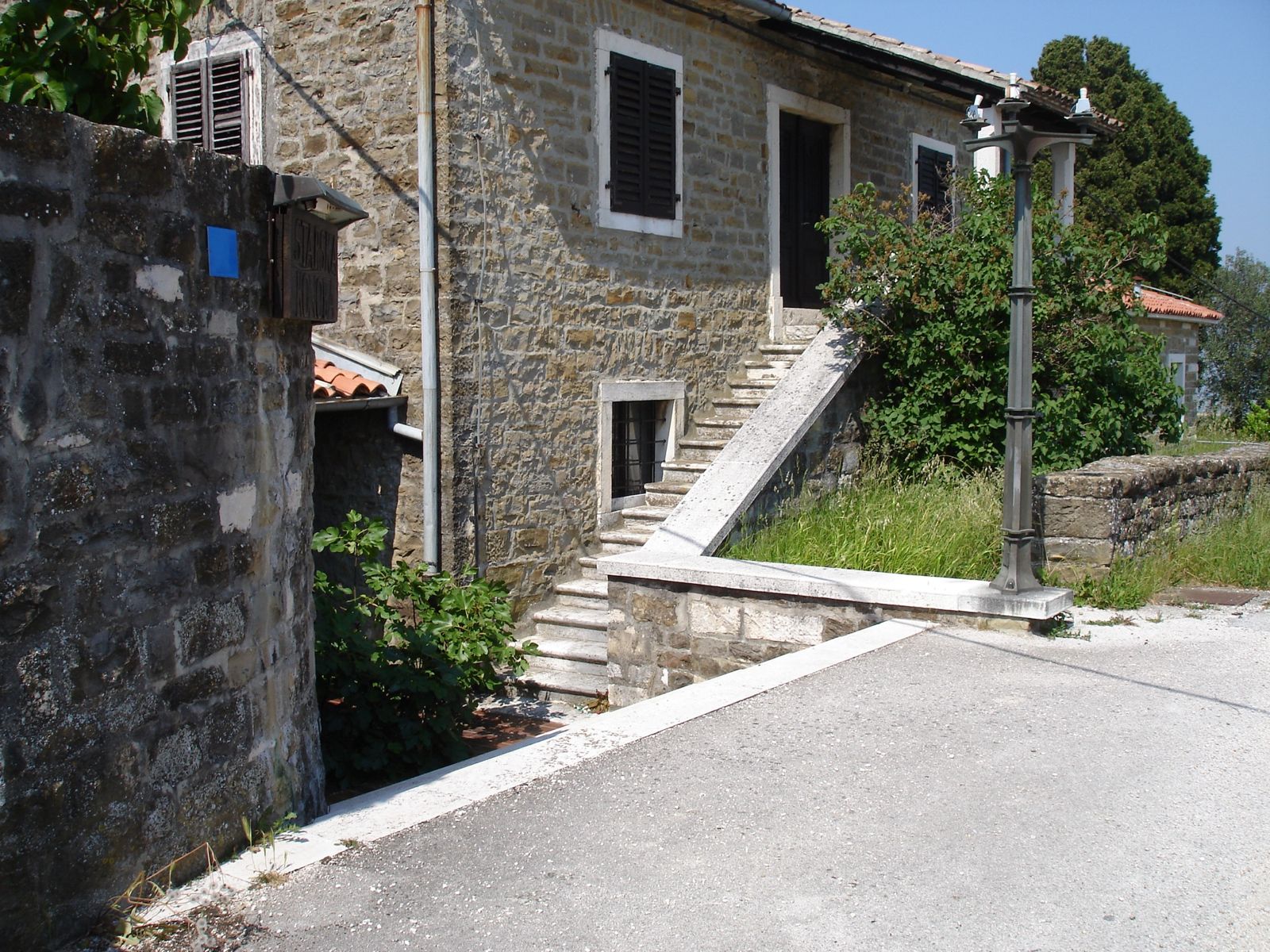 Old stone house with outside stone stairs in the village of Momjan