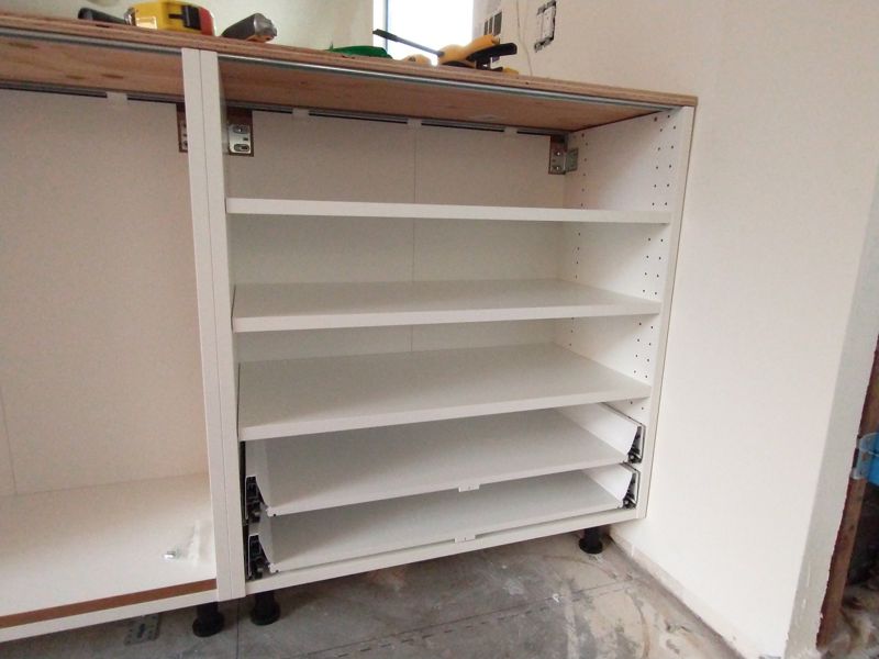 Kitchen cabinet carcasses fitted along a wall before doors and worktop are added